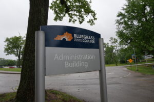 Sign for Bluegrass Community & Technical College with a sunburst logo, indicating the Administration Building label.