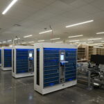Data center with white server racks filled with blue storage modules and a polished concrete floor