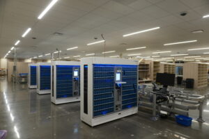 Data center with white server racks filled with blue storage modules and a polished concrete floor